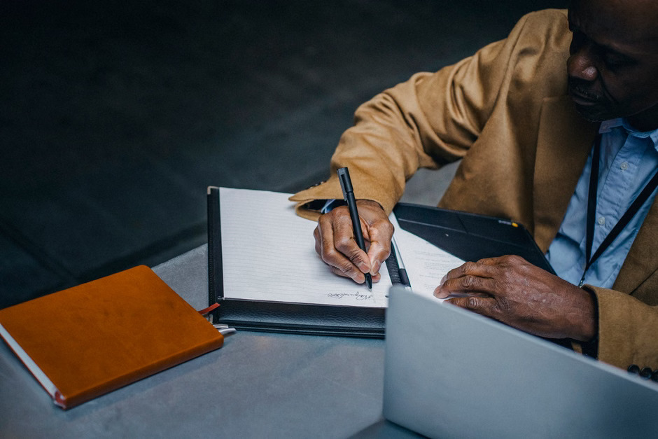 A professional notary using a mobile notary journal app to securely record a digital transaction on a tablet.
